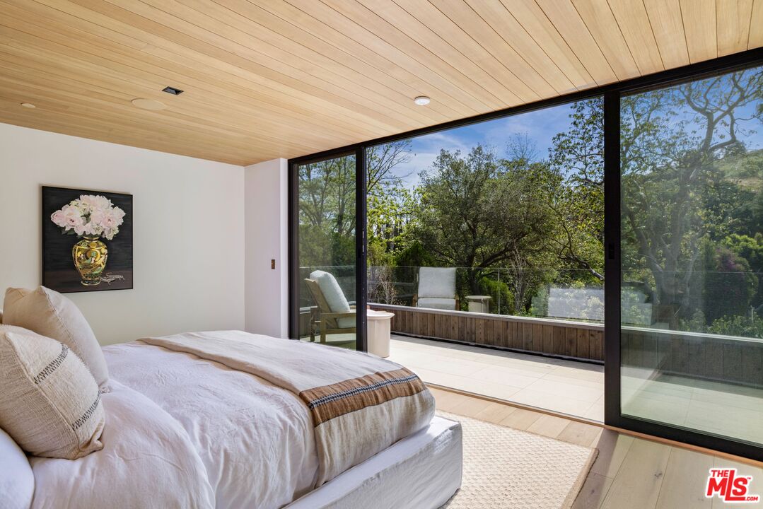 12309 Viewcrest Road Studio City, CA 91604 - Photo 32 of 49 a bedroom with a bed and a large window