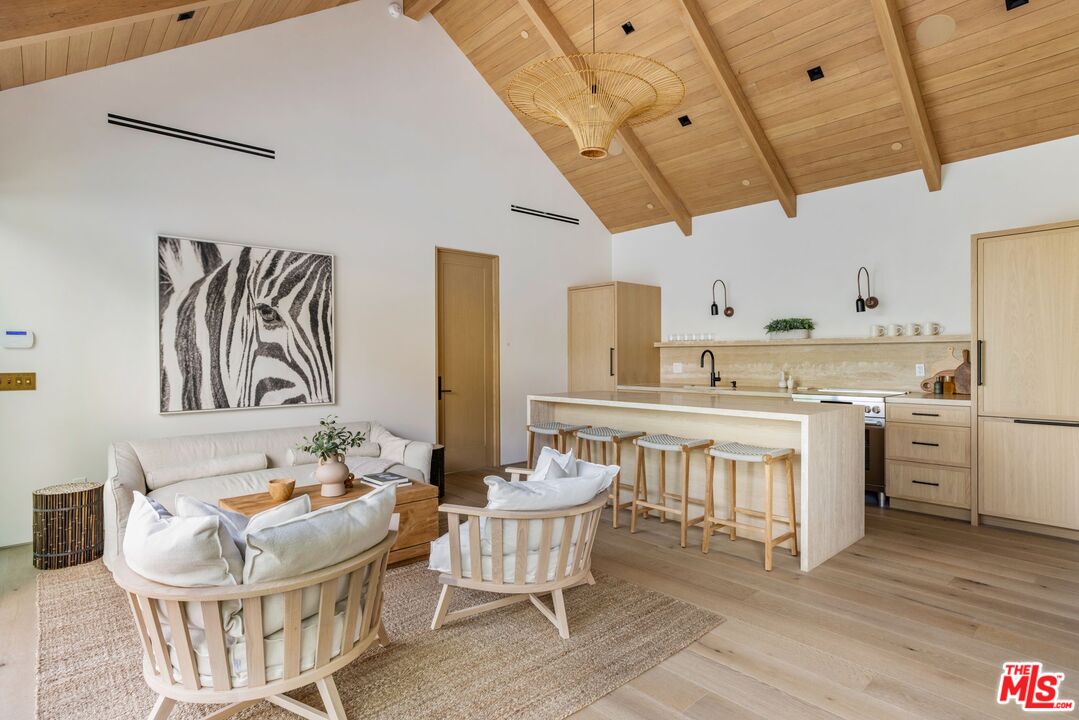 12309 Viewcrest Road Studio City, CA 91604 - Photo 43 of 49 a kitchen with a dining table chairs and white cabinets
