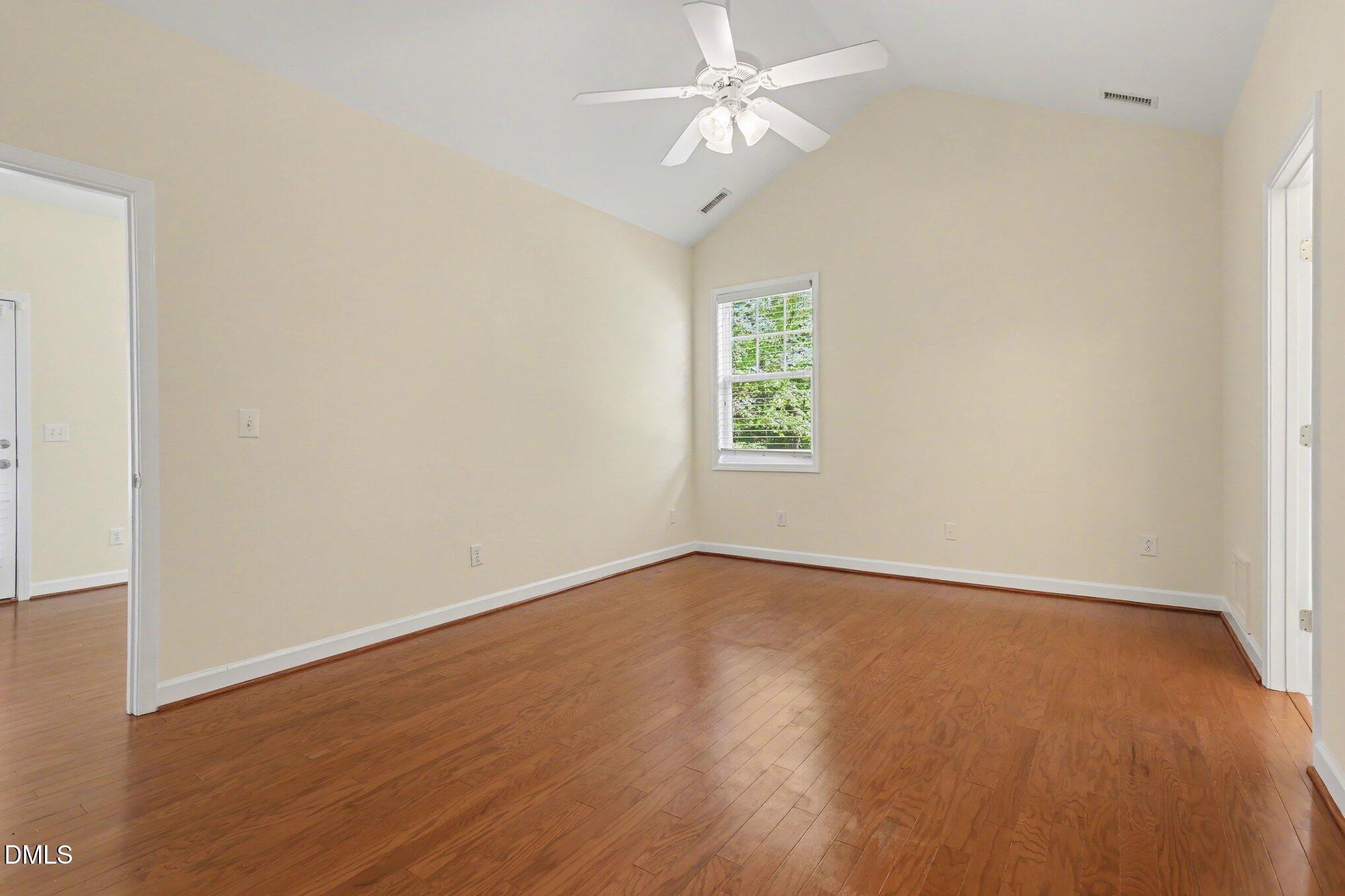133 Jennel Way Durham, NC 27707 - Photo 12 of 28 an empty room with wooden floor chandelier fan and windows
