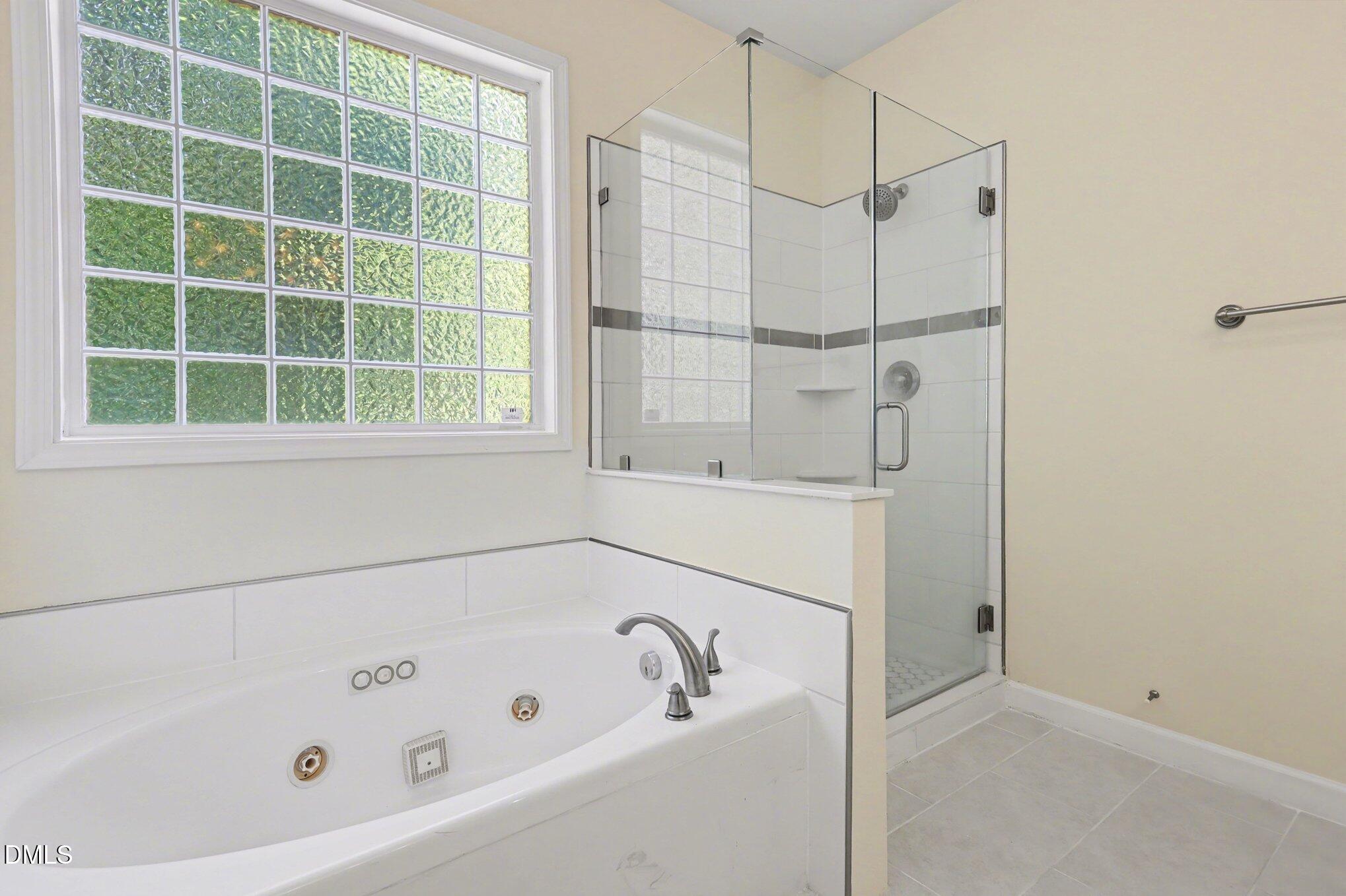 133 Jennel Way Durham, NC 27707 - Photo 16 of 28 a bathroom with a bathtub and a shower
