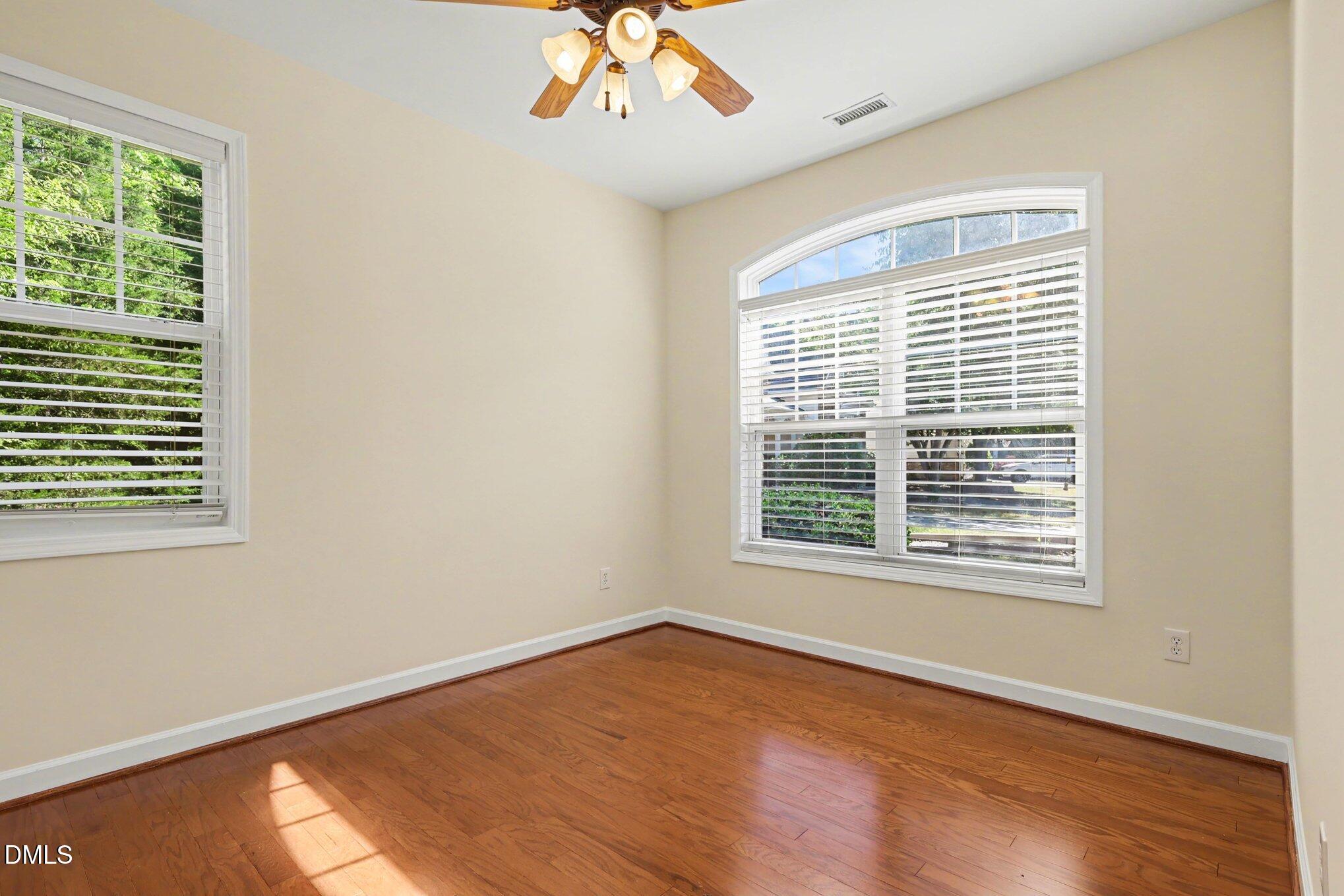 133 Jennel Way Durham, NC 27707 - Photo 17 of 28 a view of an empty room with wooden floor and a window