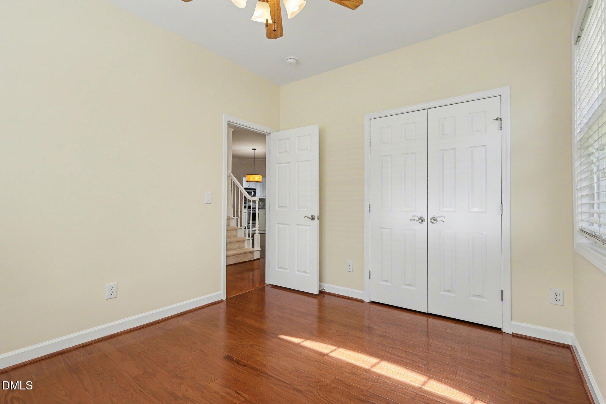 133 Jennel Way Durham, NC 27707 - Photo 18 of 28 an empty room with wooden floor closet and windows