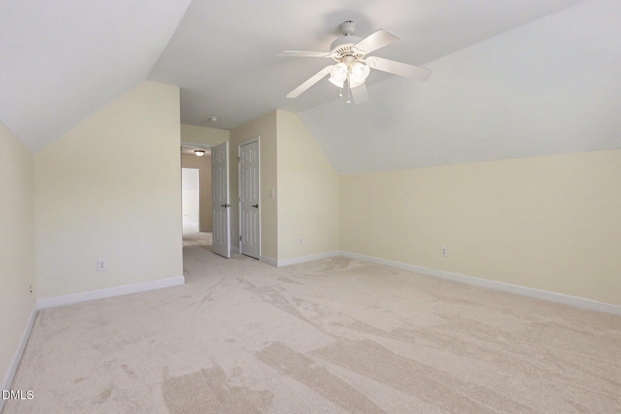 133 Jennel Way Durham, NC 27707 - Photo 24 of 28 an empty room with a chandelier fan and windows