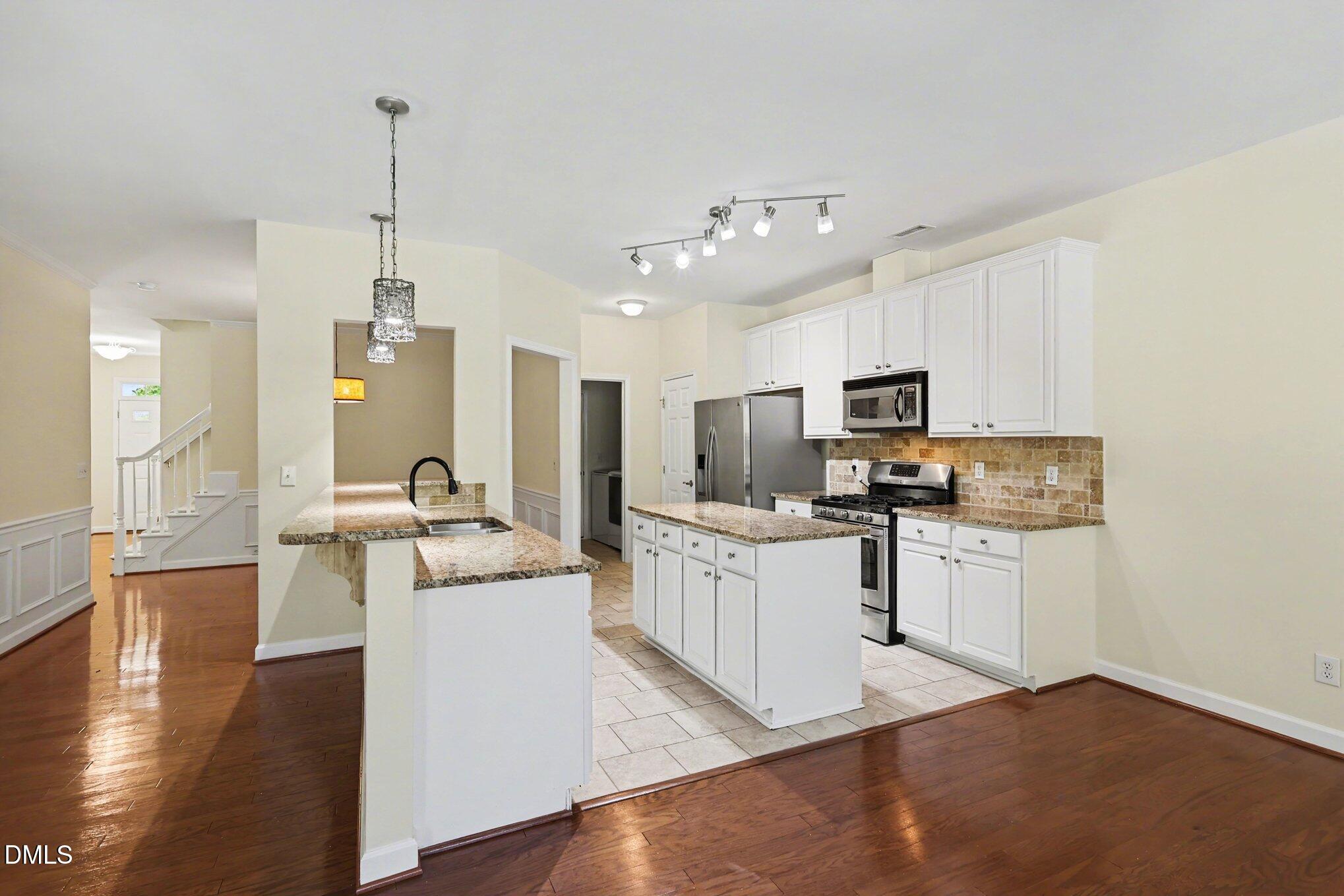 133 Jennel Way Durham, NC 27707 - Photo 7 of 28 a kitchen with kitchen island granite countertop appliances cabinets and a sink