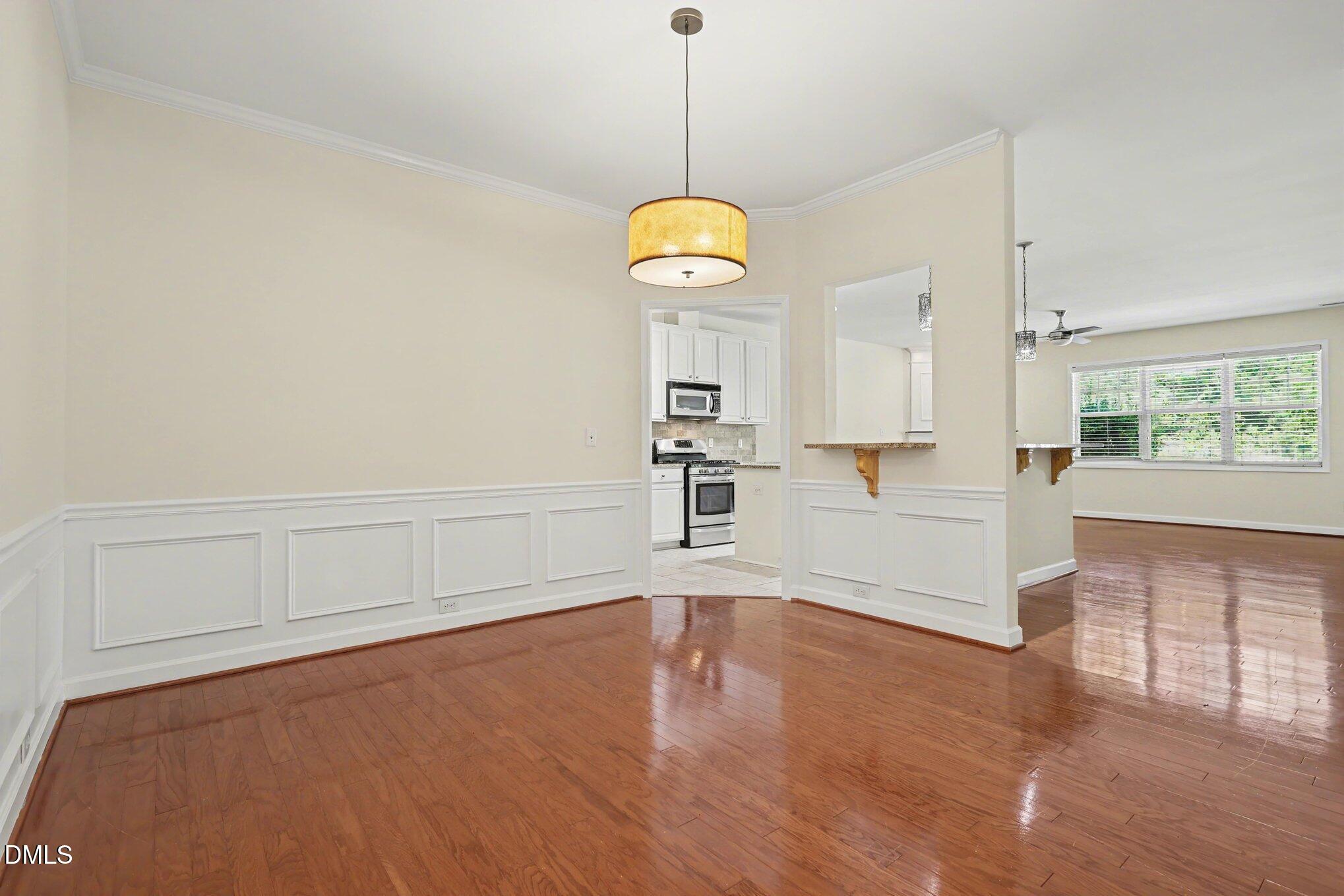 133 Jennel Way Durham, NC 27707 - Photo 9 of 28 a view of an empty room with wooden floor and windows