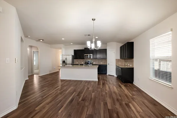 a view of kitchen with cabinets stainless steel appliances a sink and a stove