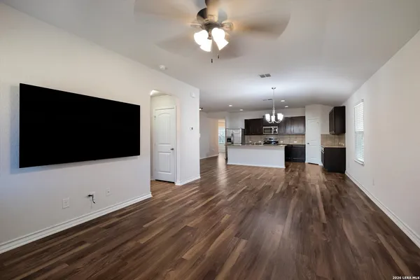 a view of kitchen with refrigerator microwave and stove top oven