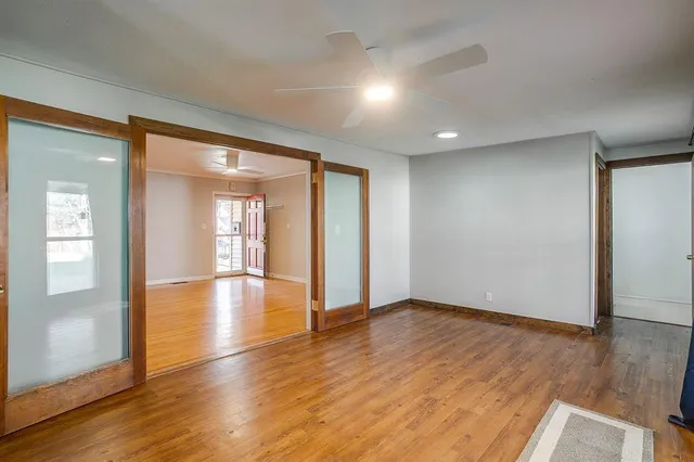 wooden floor in an empty room with a window