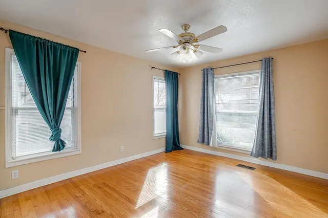 a view of a livingroom with a hardwood floor and window