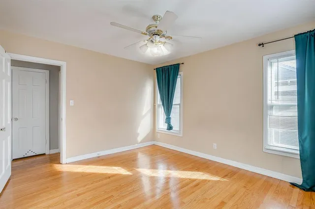 a view of a room with a ceiling fan and a window