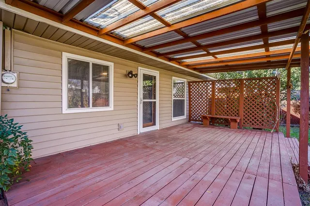 a view of backyard with a deck and wooden floor