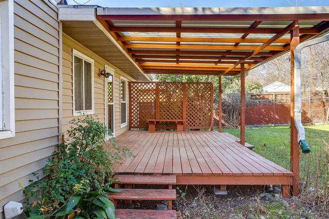 a view of backyard with a deck and wooden floor