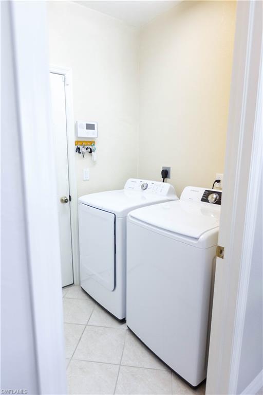 9349 Chestnut Tree Loop Fort Myers, FL 33967 - Photo 12 of 35 a utility room with dryer and washer