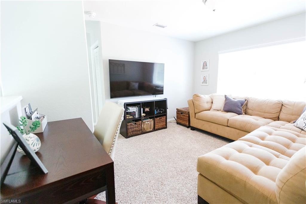 9349 Chestnut Tree Loop Fort Myers, FL 33967 - Photo 17 of 35 a living room with furniture and a flat screen tv