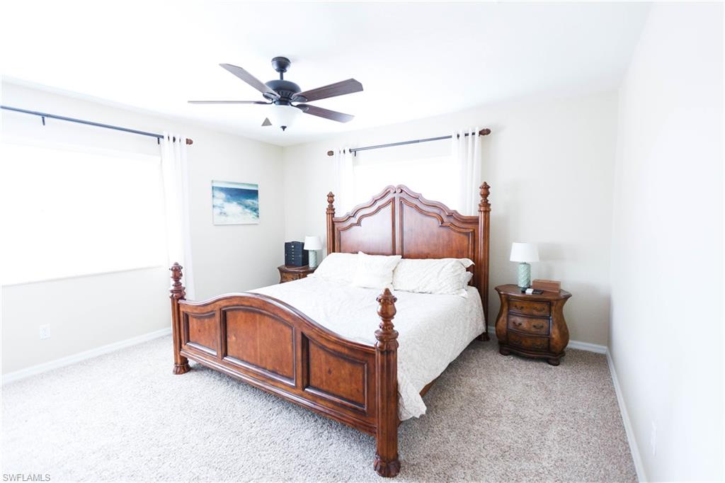 9349 Chestnut Tree Loop Fort Myers, FL 33967 - Photo 19 of 35 a bedroom with a bed and window