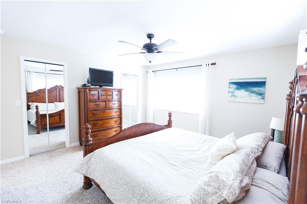 9349 Chestnut Tree Loop Fort Myers, FL 33967 - Photo 20 of 35 a bedroom with a bed and a flat screen tv
