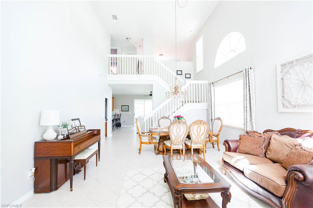 9349 Chestnut Tree Loop Fort Myers, FL 33967 - Photo 2 of 35 a living room with furniture and a chandelier