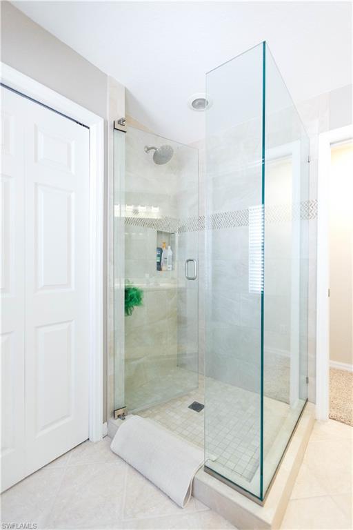 9349 Chestnut Tree Loop Fort Myers, FL 33967 - Photo 22 of 35 a bathroom with a shower and a sink