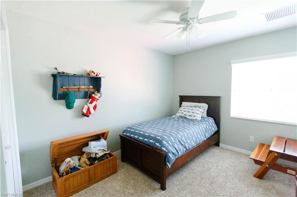9349 Chestnut Tree Loop Fort Myers, FL 33967 - Photo 24 of 35 a bedroom with a bed and a window