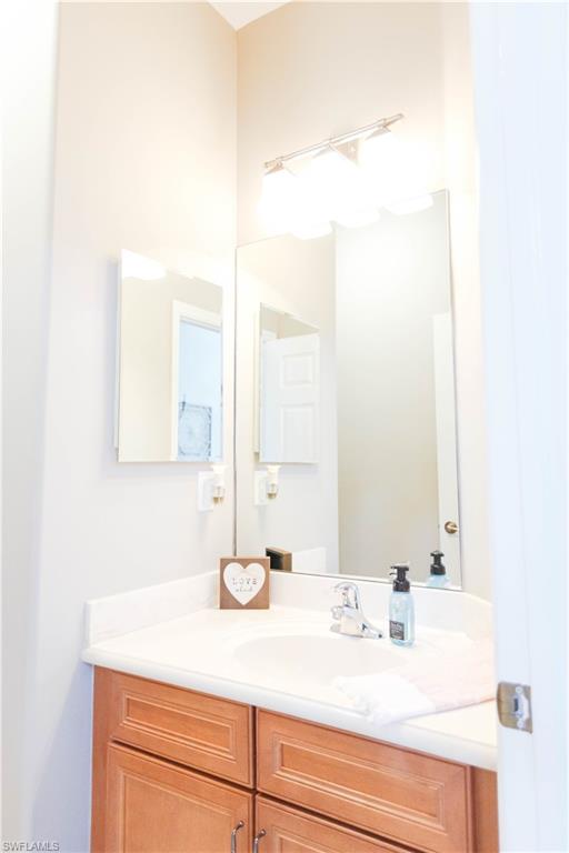 9349 Chestnut Tree Loop Fort Myers, FL 33967 - Photo 26 of 35 a bathroom with a sink and a mirror
