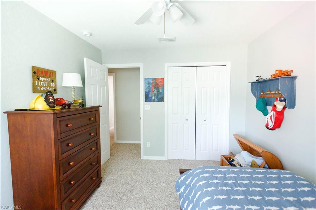 9349 Chestnut Tree Loop Fort Myers, FL 33967 - Photo 27 of 35 a bedroom with a bed and a dresser
