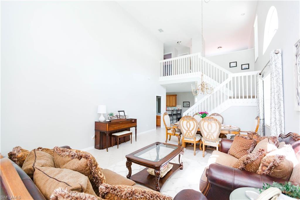 9349 Chestnut Tree Loop Fort Myers, FL 33967 - Photo 3 of 35 a living room with furniture and a chandelier