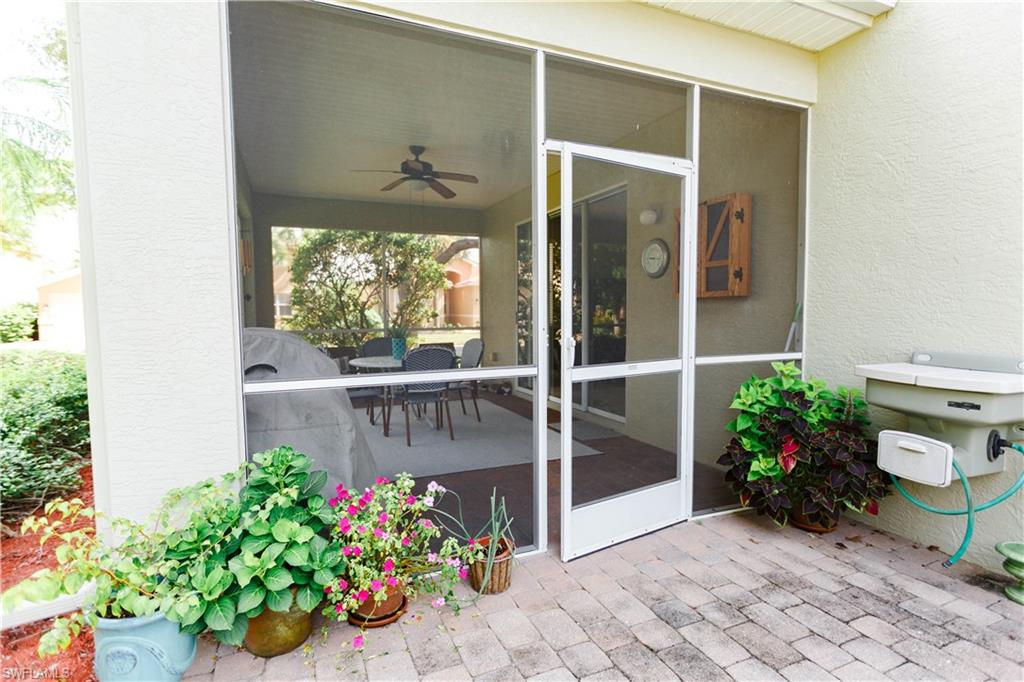 9349 Chestnut Tree Loop Fort Myers, FL 33967 - Photo 31 of 35 a front view of a house with a garden