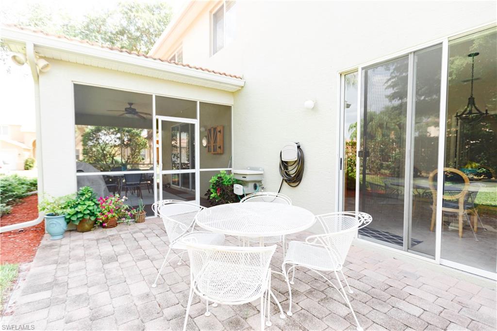 9349 Chestnut Tree Loop Fort Myers, FL 33967 - Photo 32 of 35 a view of a patio with a table chairs and a porch
