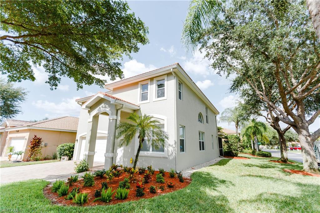 9349 Chestnut Tree Loop Fort Myers, FL 33967 - Photo 35 of 35 a front view of a house with a yard and potted plants