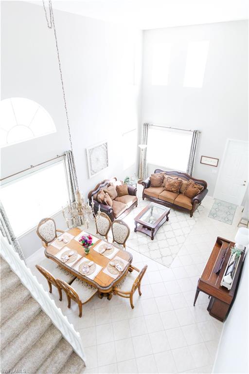 9349 Chestnut Tree Loop Fort Myers, FL 33967 - Photo 4 of 35 a dining room with furniture and wooden floor