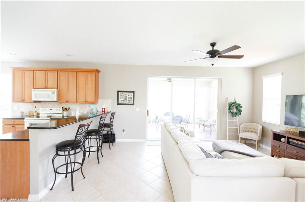 9349 Chestnut Tree Loop Fort Myers, FL 33967 - Photo 9 of 35 a living room with furniture and a large window