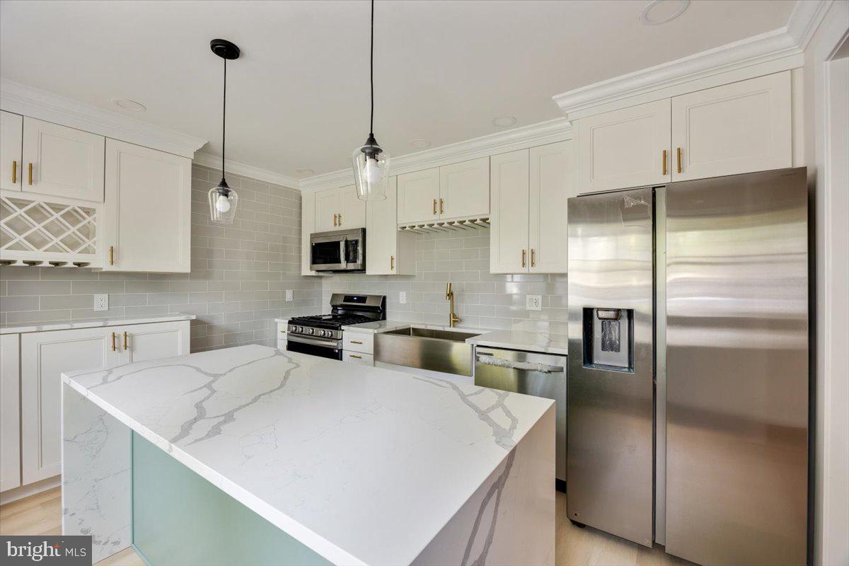 63 Baker Boulevard Marlton, NJ 08053 - Photo 13 of 38 a kitchen with a refrigerator a sink a counter space and cabinets