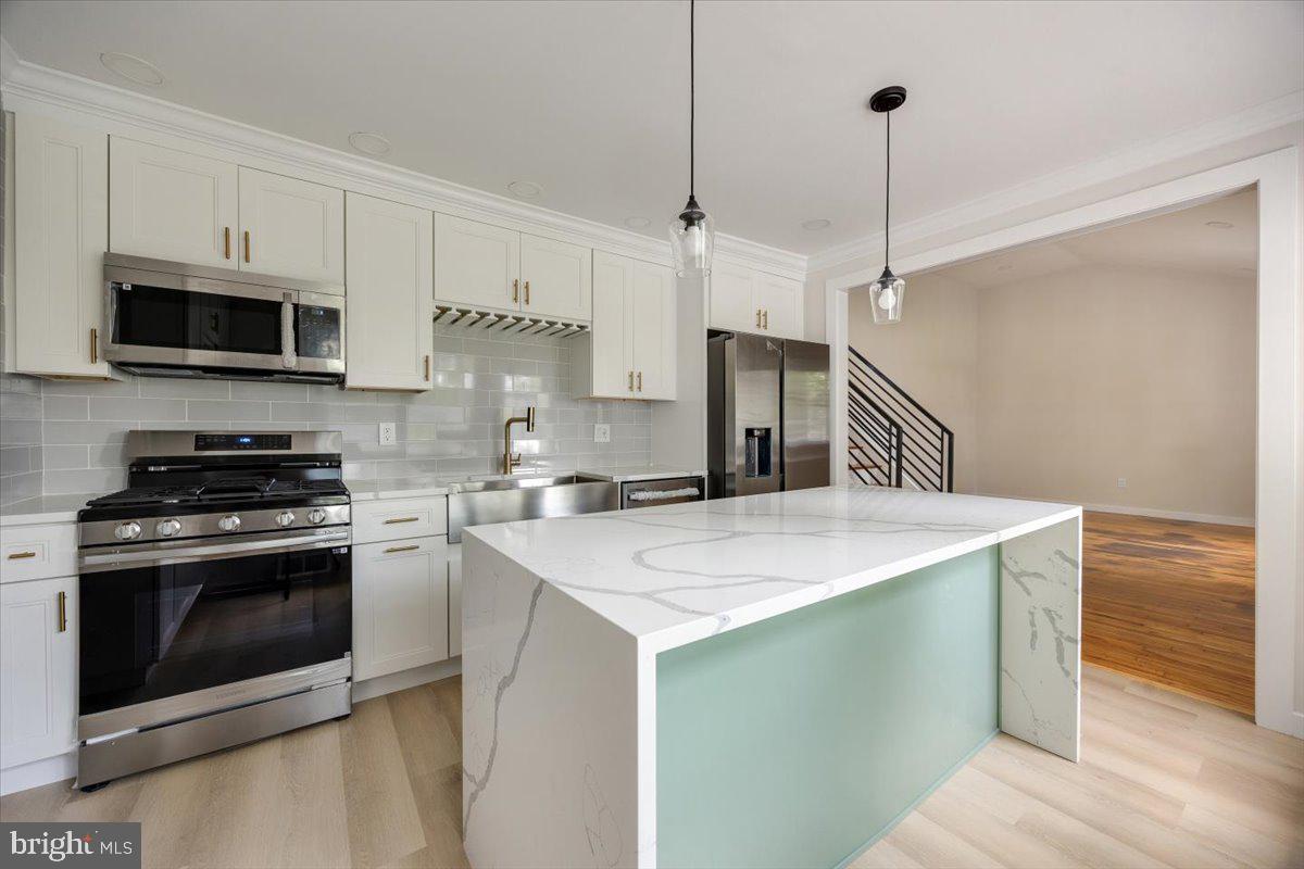 63 Baker Boulevard Marlton, NJ 08053 - Photo 14 of 38 a kitchen with a sink stove and microwave