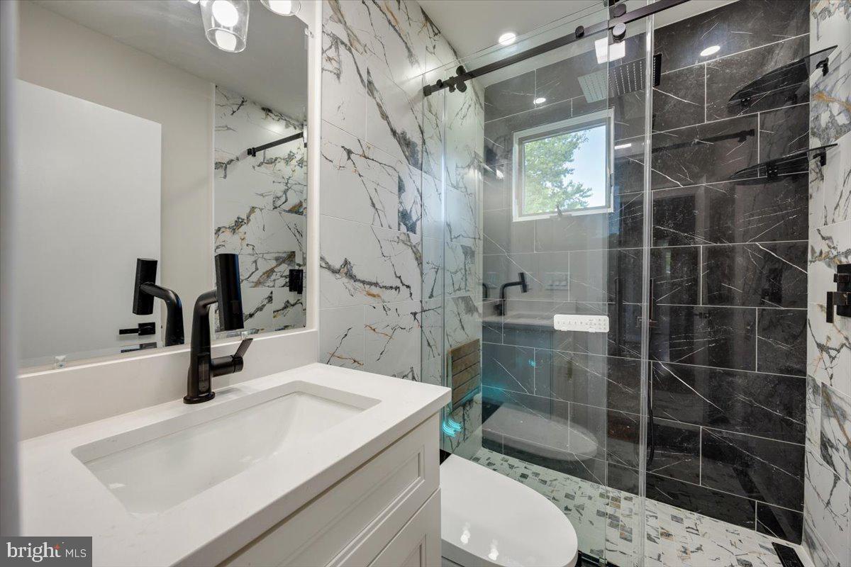 63 Baker Boulevard Marlton, NJ 08053 - Photo 25 of 38 a bathroom with a sink a toilet and shower