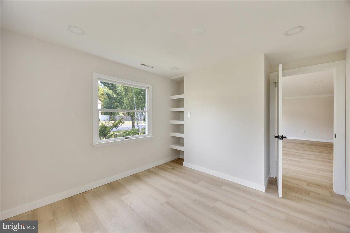 63 Baker Boulevard Marlton, NJ 08053 - Photo 27 of 38 an empty room with wooden floor closet and windows
