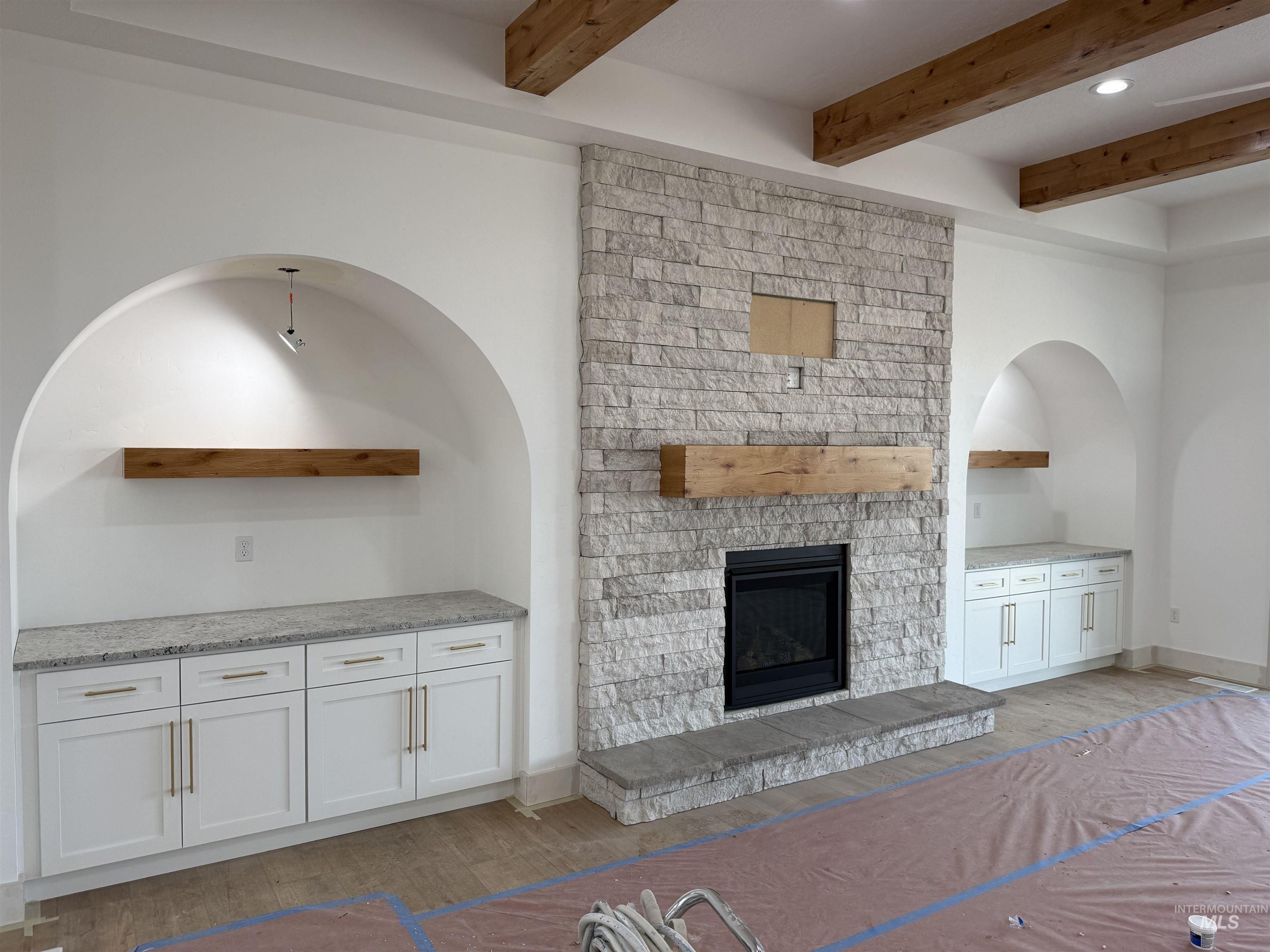 23739 Legends Lane Caldwell, ID 83607 - Photo 6 of 9 Unfurnished living room featuring wood finished floors, a fireplace, beam ceiling, and recessed lighting