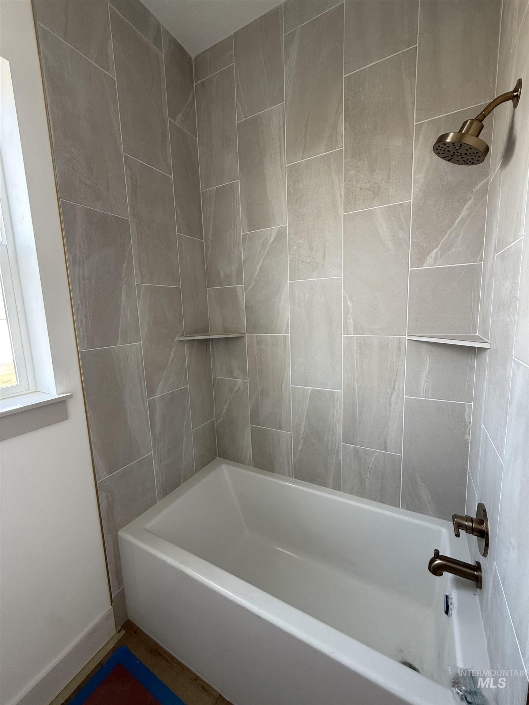 23739 Legends Lane Caldwell, ID 83607 - Photo 9 of 9 Bathroom featuring shower / washtub combination and baseboards