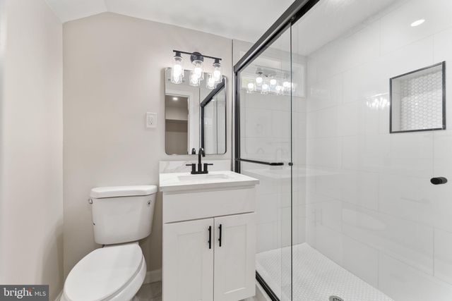 a bathroom with a toilet a sink and mirror