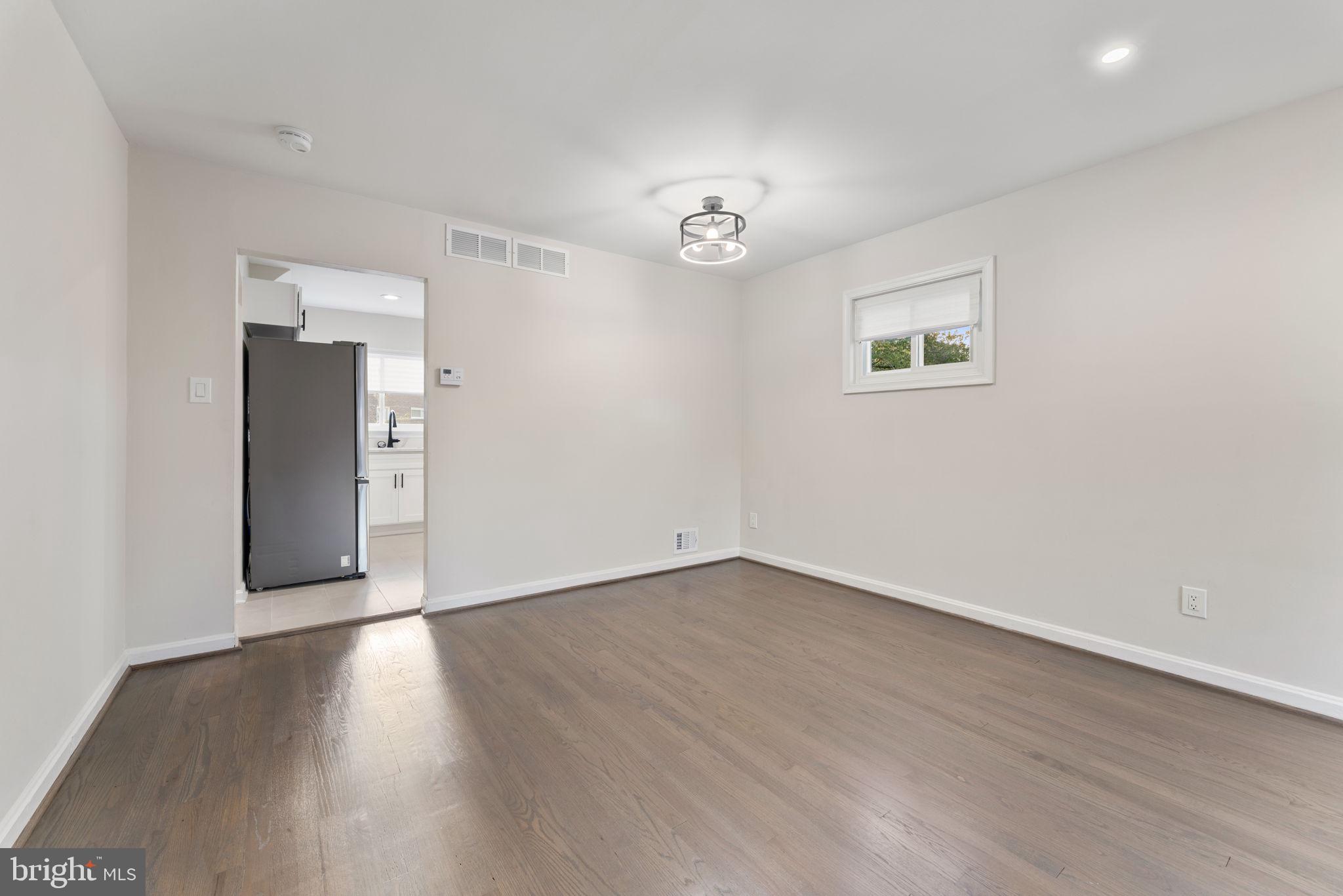 2605 Keith Street Temple Hills, MD 20748 - Photo 4 of 20 an empty room with wooden floor and windows