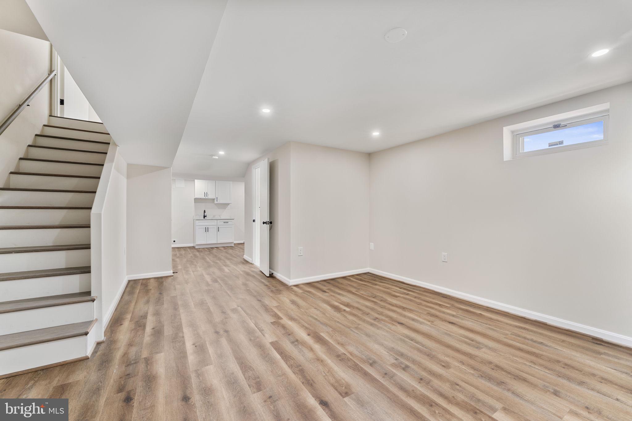 2605 Keith Street Temple Hills, MD 20748 - Photo 10 of 20 a view of hallway with stairs and wooden floor