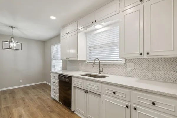 a kitchen with a sink cabinets and window