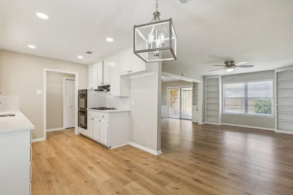 a view of a kitchen with furniture and wooden floor