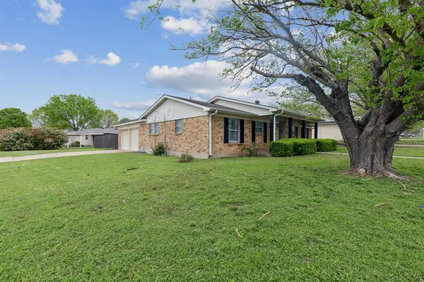 a front view of house with yard and green space