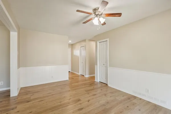 a view of an empty room with wooden floor