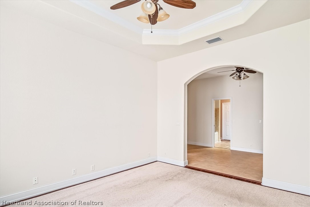 5224 Haw Branch Road Sebring, FL 33875 - Photo 19 of 40 a view of a hallway with a chandelier fan