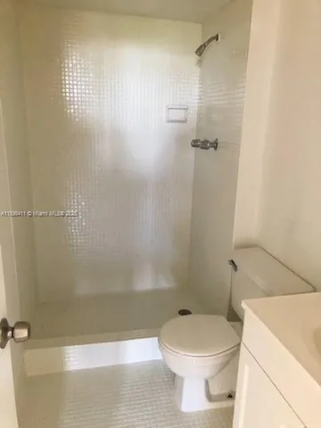 a bathroom with a toilet and shower