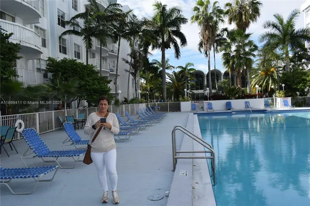 a view of swimming pool with a table and chairs