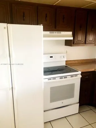 a stove top oven sitting inside of a kitchen