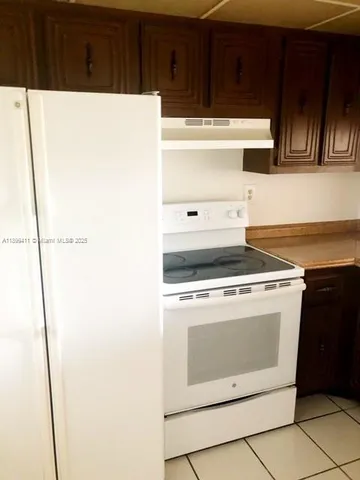 a stove top oven sitting inside of a kitchen