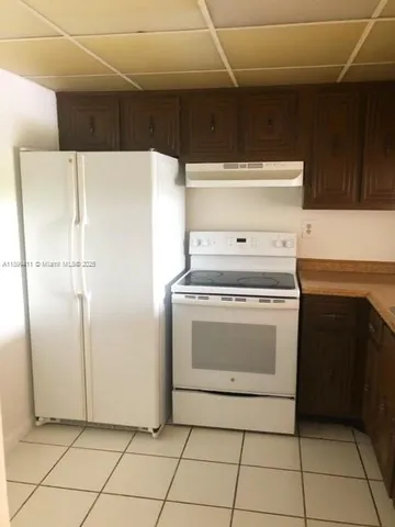 a stove top oven sitting inside of a kitchen